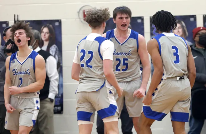 Novi Detroit Catholic Central's Cooper Craggs (25) celebrates with teammates after getting a basket and the foul for a three-point play to take the lead over Birmingham Brother Rice during CC's 66-64 win in the Catholic League quarterfinals at Bloomfield Hills Marian on Saturday, Feb. 19, 2022. (Eric Seals, Detroit Free Press)