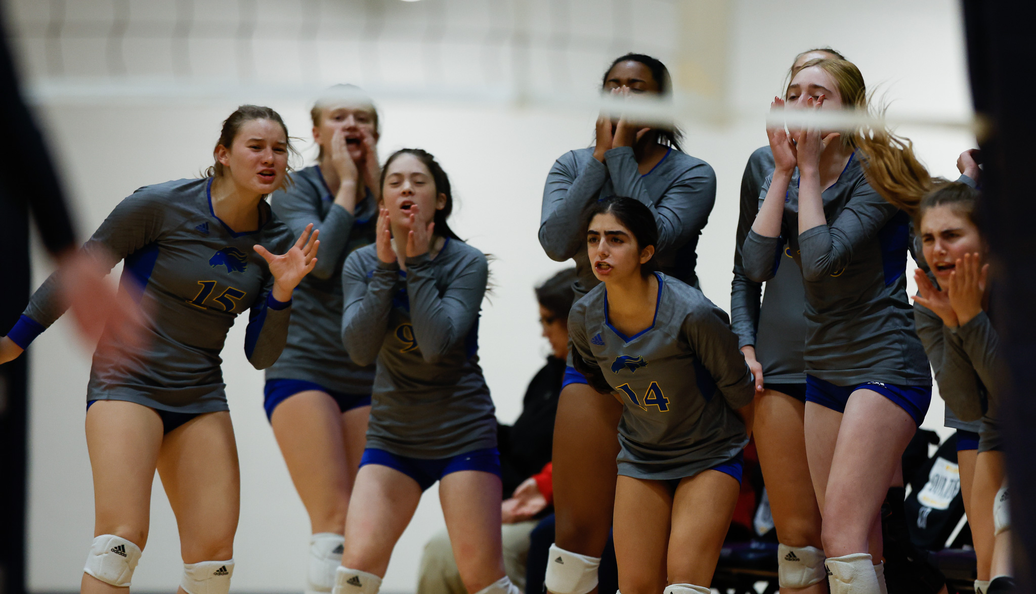 The Marian sideline reacts to a crucial point.